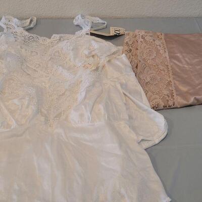 Lot 133: (4) New White Lace Trimed Camisoles and one Tan Long Lace Trimed Split Skirt Slip