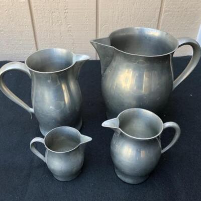 Lot 33P. 4 Pewter pitchers in various sizes â€” $37.50
