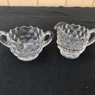 Lot 58L.  Fostoria American Glassware: 3 Creamers, 1 Sugar bowl, 1 vase, 2 round divided bowls, 1 Nappy bowl â€” $40