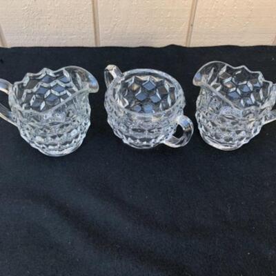 Lot 58L.  Fostoria American Glassware: 3 Creamers, 1 Sugar bowl, 1 vase, 2 round divided bowls, 1 Nappy bowl â€” $40