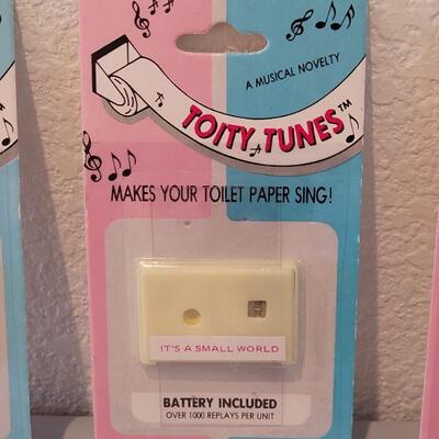 Lot 139: Pull Sting Music Box and (3)  Toity Tunes (makes your toliet paper sing)