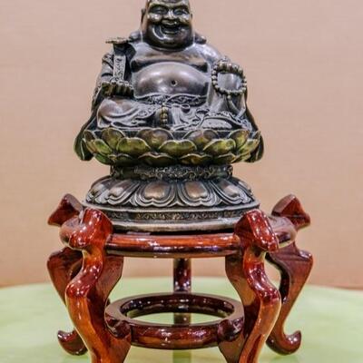 Bronze laughing Buddha on cherry wood stand