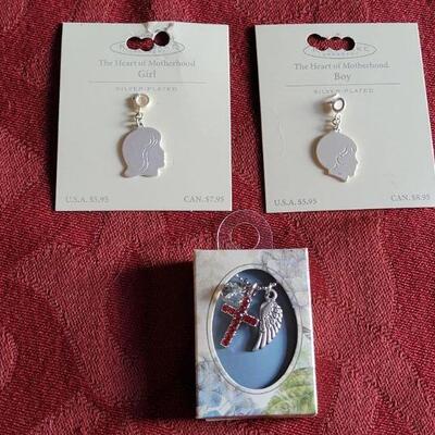 Lot 361: New Hallmark Boy & Girl Charm and Cross and Angel Wing Necklace