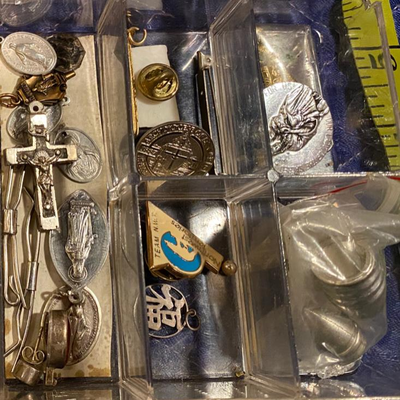 Box of religious metals and pins