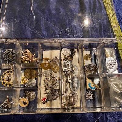 Box of religious metals and pins