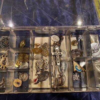Box of religious metals and pins