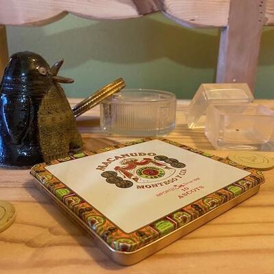 A tin cigar box, 2 glass boxes and a clay penguin