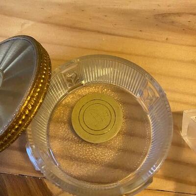 A tin cigar box, 2 glass boxes and a clay penguin
