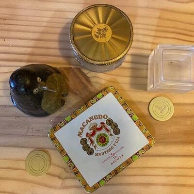 A tin cigar box, 2 glass boxes and a clay penguin
