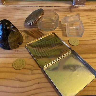 A tin cigar box, 2 glass boxes and a clay penguin