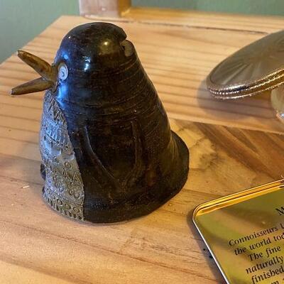 A tin cigar box, 2 glass boxes and a clay penguin