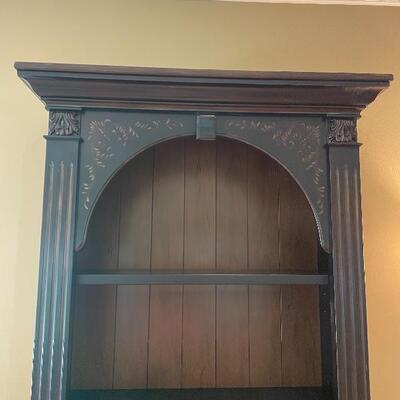 Beautiful bookshelf with subtle hand painting detail 
