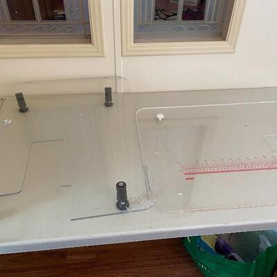 Two sewing machine work surfaces