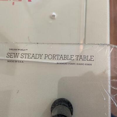 Two sewing machine work surfaces