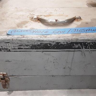 LOT 84 - Heavy metal toolbox of saws, attachments, etc