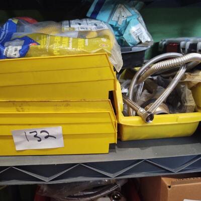 lot 132 =-Yellow bins of assorted plumbing parts on top of table