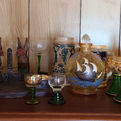 Lot 152: Steins, Ship Decanter, German Wood Carved Ashtray Set and More