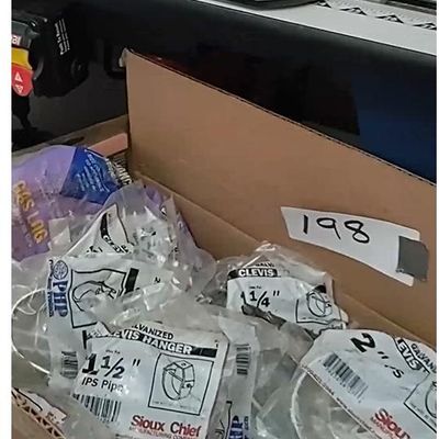 lot 198 - assorted plumbing parts in original packaging - galvanized clevis hangers, gas log part, etc.