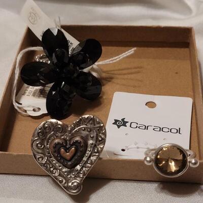 Lot 96: (3) New Rings (Silver with Smoky Topaz, Multi Metal Heart and Stretch Black Beaded Flower Ring)