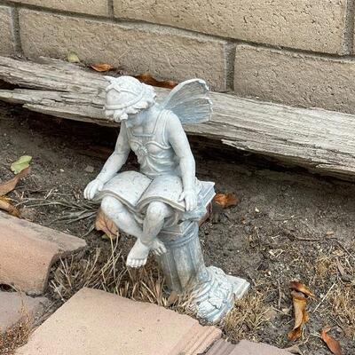 Garden art statue, fairy reading a book