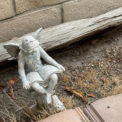 Garden art statue, fairy reading a book