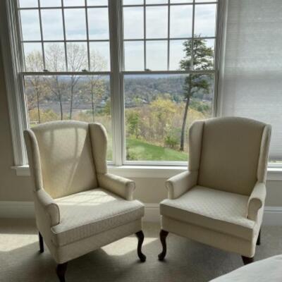 Pair of cream wingback chairs