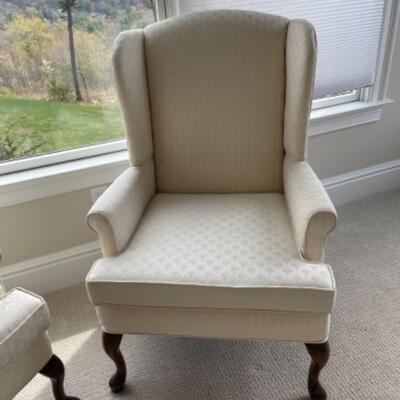 Pair of cream wingback chairs