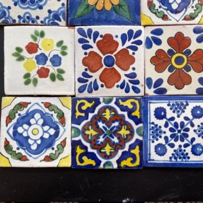 Lot 26LD. Mexican Talavera ceramic tiles—ten 4”x4” and twenty 2”x2”, all adapted for wall hanging--$125