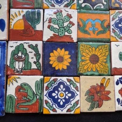 Lot 26LD. Mexican Talavera ceramic tiles—ten 4”x4” and twenty 2”x2”, all adapted for wall hanging--$125