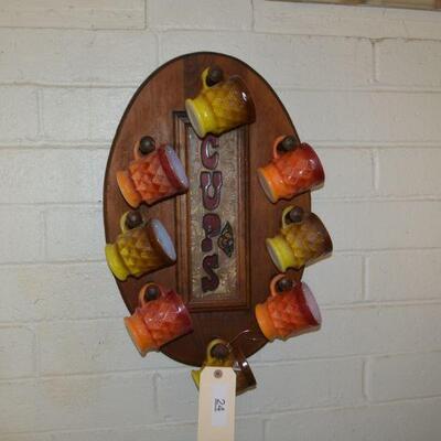 LOT 24. Vintage Wall mounted cup rack with six mugs