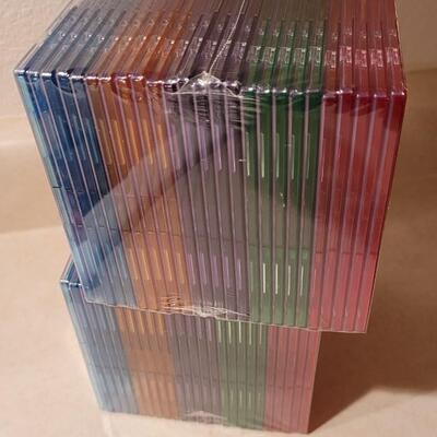 Lot 143: New Colored Slim Jewel Cases (50 Total) 