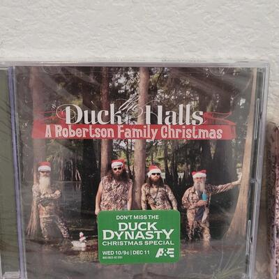 Lot 341: Duck Dynasty CD, Playing Cards and God Bless Photo Visor Clip