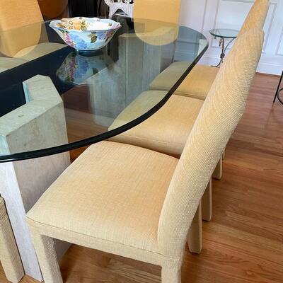 Fabulous glass and marble dining table with freshly upholstered pale yellow chairs