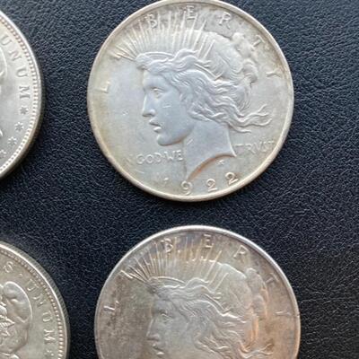 Antique silver dollar collection of four. Includes two 1921 Morgans and two 1922 Peace. Lot A16