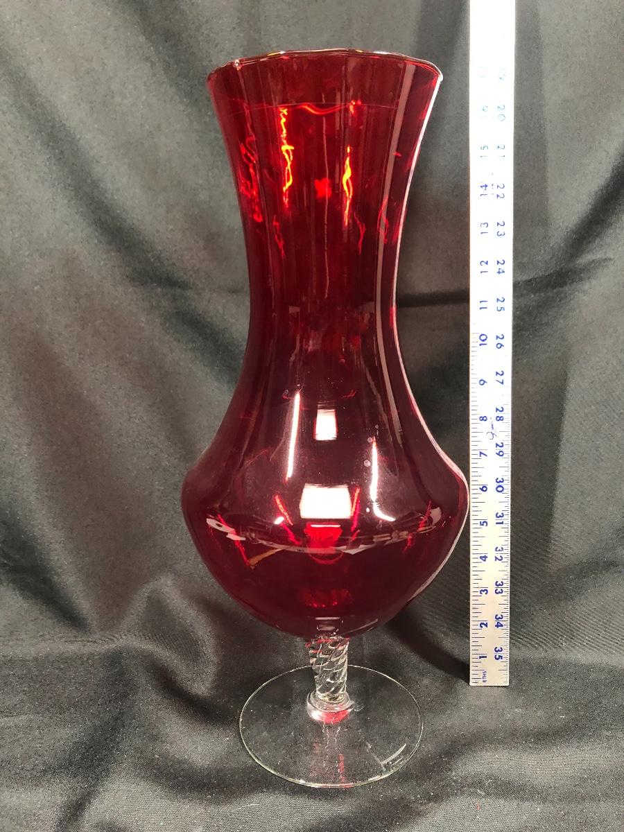 Large red glass vase with clear pedestal base