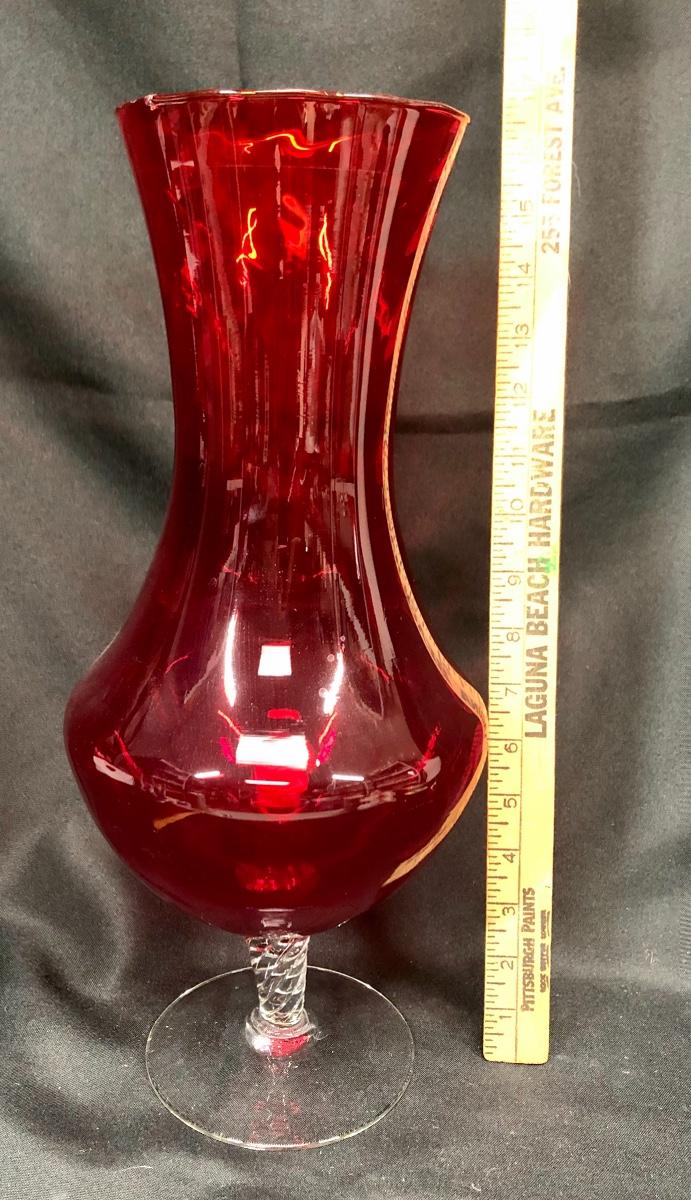 Large red glass vase with clear pedestal base