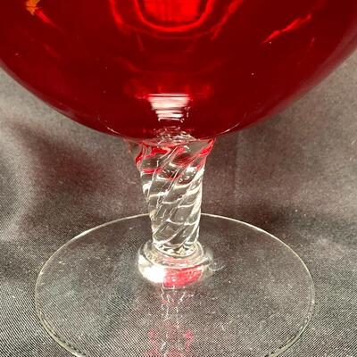 Large red glass vase with clear pedestal base