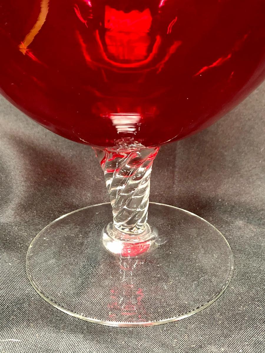 Large red glass vase with clear pedestal base