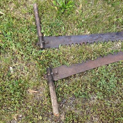 Pair of antique two person saws. 64â€ and 69â€ long