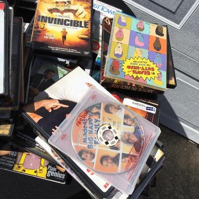 Collection of movie and media with 41 DVDs and 12 eight track tapes