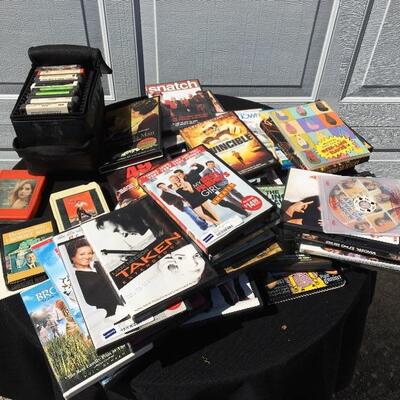 Collection of movie and media with 41 DVDs and 12 eight track tapes