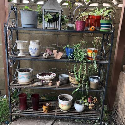 Wrought iron 4 shelf plant rack with plants
