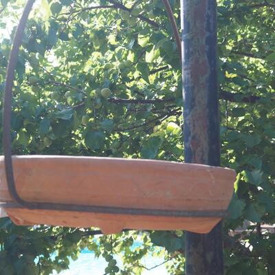 Lot 81 Rustic iron hanger and large terracotta low planter pot