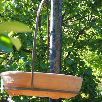Lot 81 Rustic iron hanger and large terracotta low planter pot