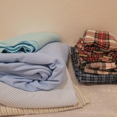 Lot 98: Mixed Polyester and Flannel Fabric (Polyester and Cotton Plaid -more than 5 yards, Flannels around 2 yards))