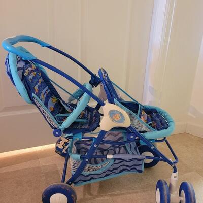 Lot 282: Doll Fisher Price Double Stroller 