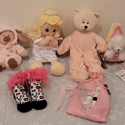 Lot 104: New Baby Girl Plushies, Praying Doll, Stroller Cover and Socks 
