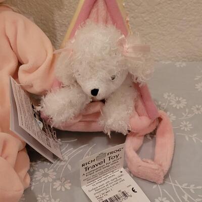 Lot 104: New Baby Girl Plushies, Praying Doll, Stroller Cover and Socks 