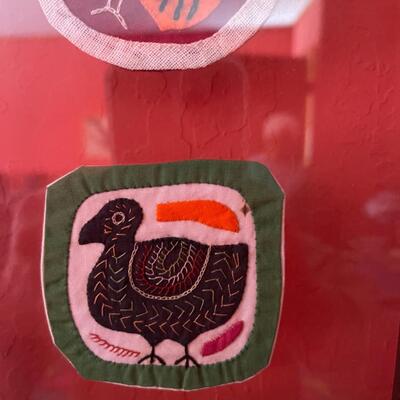 Item 38. Peruvian framed Kuna Mola textile art, five round patches, bird motifs. Circa 1970â€™s.