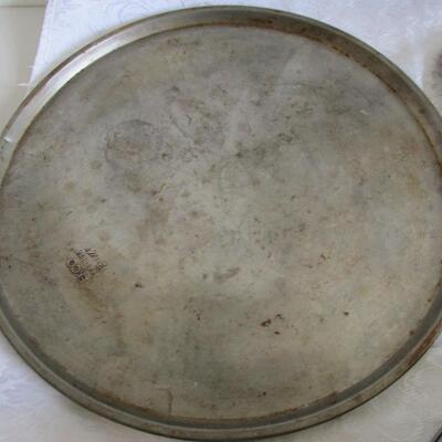 #51 Pizza pan, griddle, tea pot, measuring cup, an biscuit cutter
